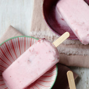 Two bowls with one Yogurt Ice Pop each in them. They are made with Mountain High Yoghurt, fresh berries, and honey.